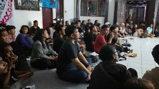 Foto penonton menyaksikan nobar film Pesta Babi hingga memenuhi ruangan dan sebagian melihat dari balik kaca jendela di Palangka Raya.