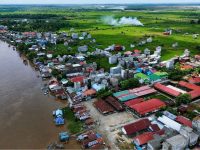 Foto udara Kelurahan Mengkatip di Kecamatan Dusun Hilir, Kabupaten Barito Selatan, yang memperlihatkan permukiman di tepi sungai dan kawasan lahan terbuka.