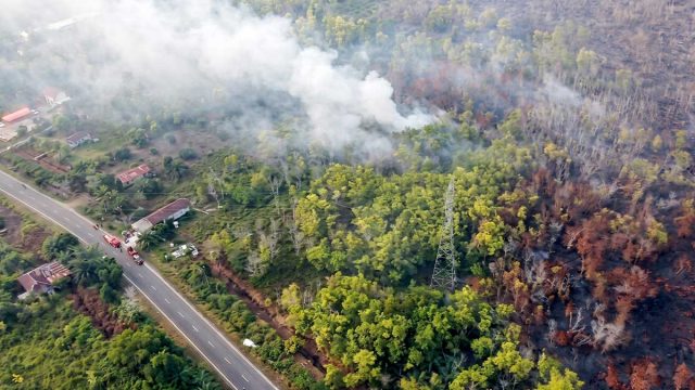 Foto udara kebakaran hutan dan lahan di kawasan yang berbatasan antara Kelurahan Kameloh Baru dan Desa Tumbang Nusa, dengan kepulan asap terlihat di sekitar lokasi.